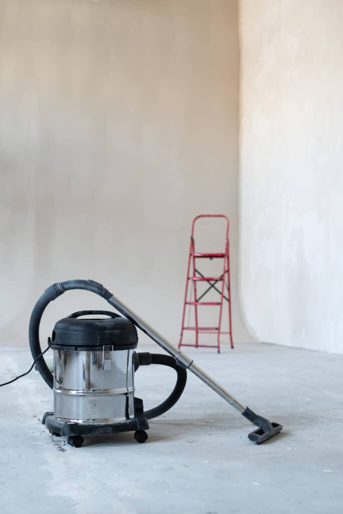 industrial vacuum cleaner at new house construction site, wide banner photo, space for text. Concept cleaning service and cleanup work.
